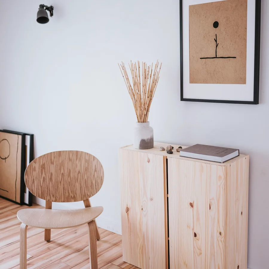 Low ash cabinet with a stool and dried grasses