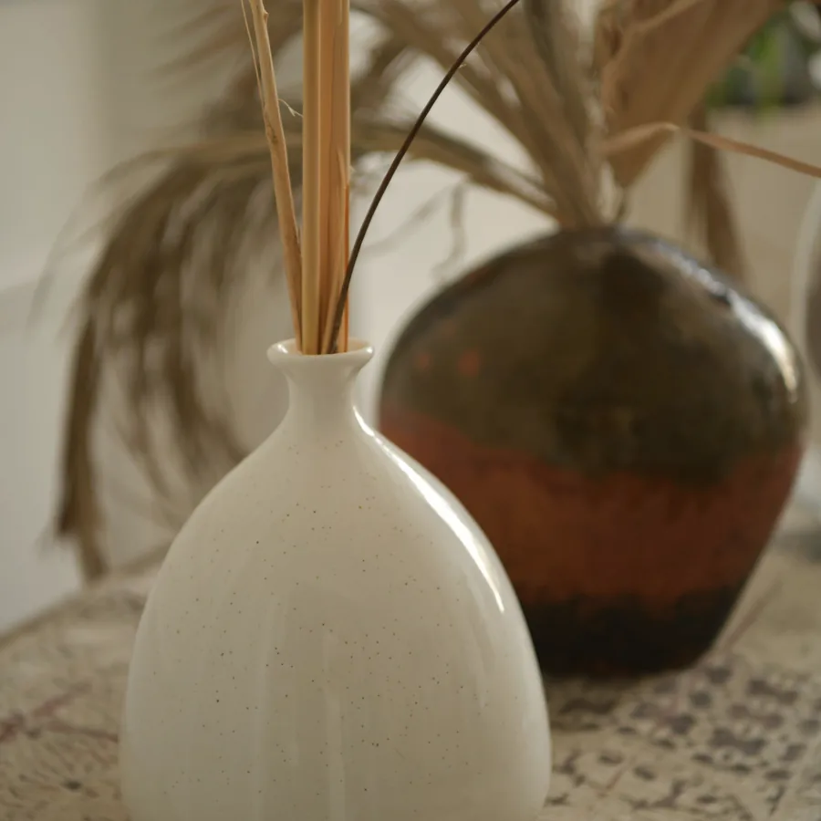 Wheel-thrown stoneware vase with dried stems