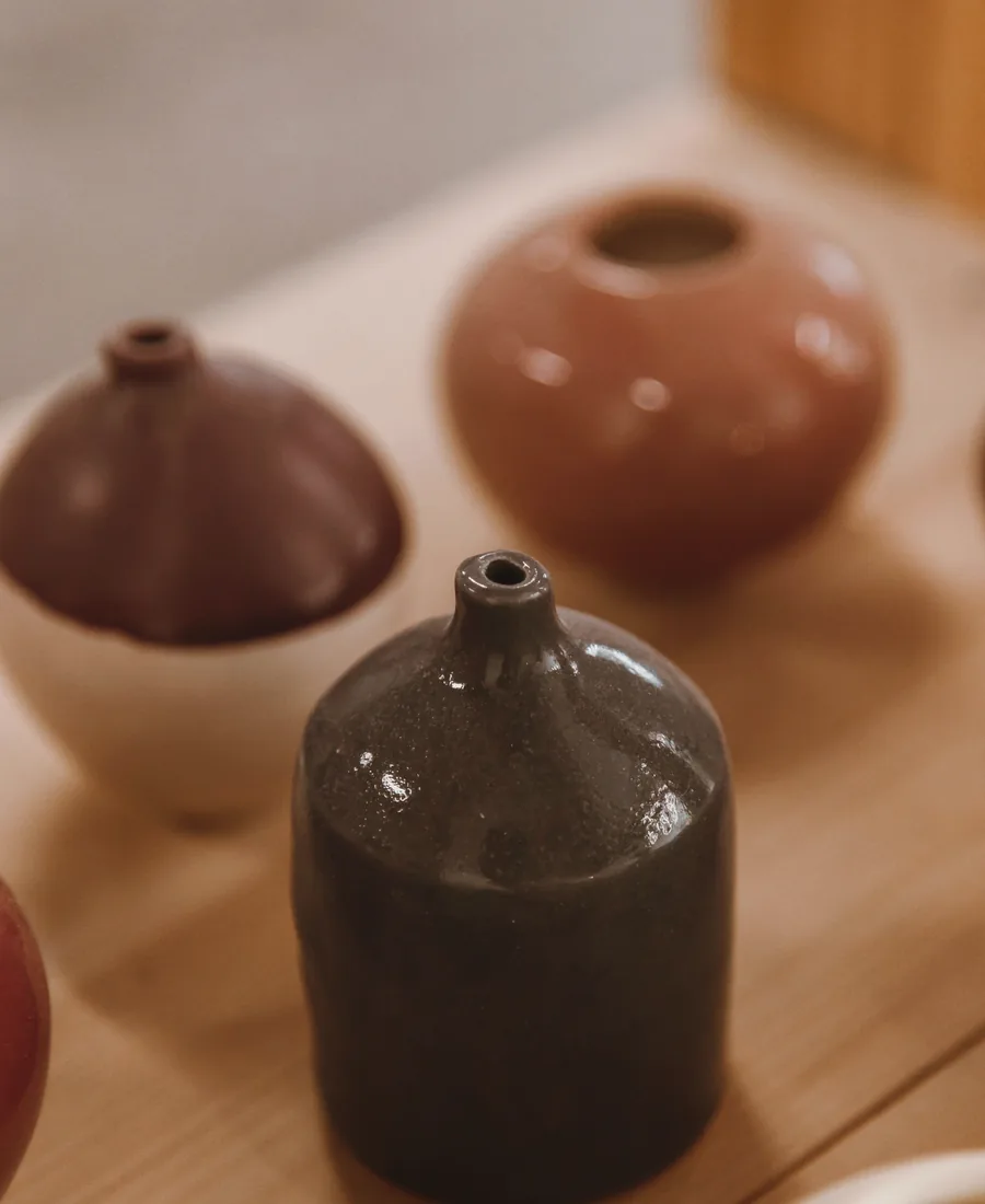 Dark stoneware vessels in the ceramics studio